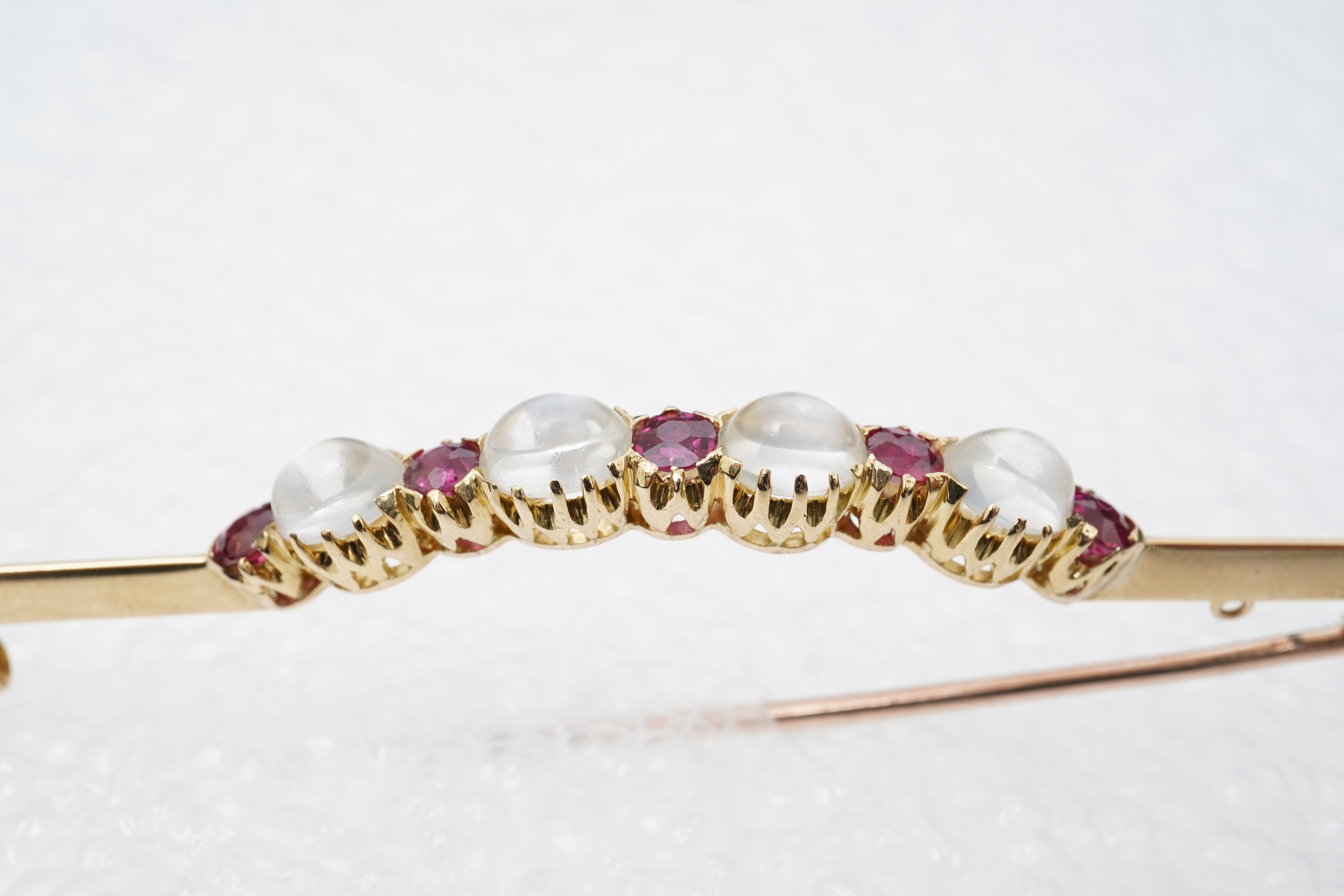 A moonstone and ruby brooch, circa 1900